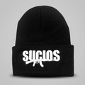 A black knit beanie hat with a white embroidered logo on the front cuff. The logo features the word 'SUCIOS' in bold white letters above a white rifle silhouette.